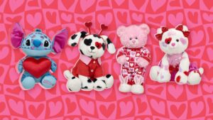 A Build-A-Bear Dalmatian with heart-shaped spots, dressed in a red scarf, alongside Valentine-themed plush animals