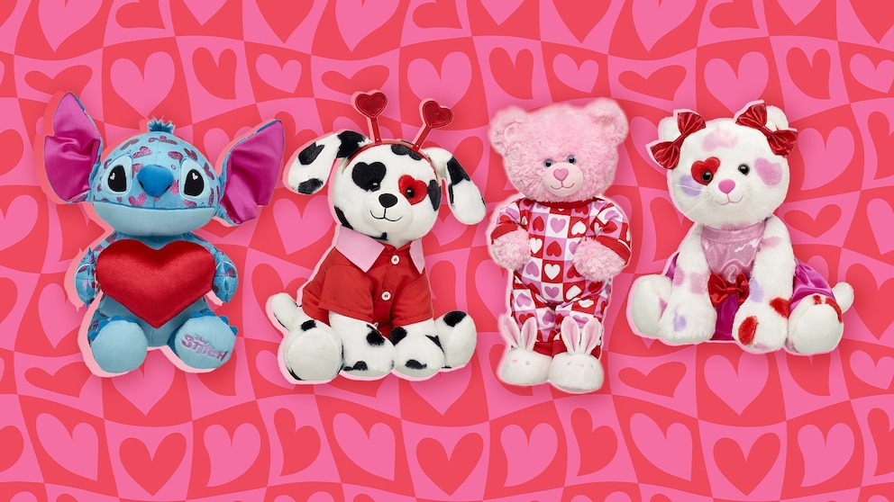 A Build-A-Bear Dalmatian with heart-shaped spots, dressed in a red scarf, alongside Valentine-themed plush animals