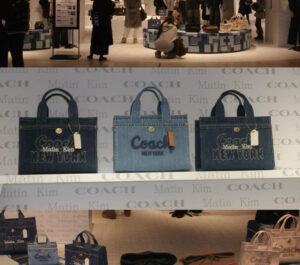 A reimagined COACH handbag featuring denim patchwork, blending classic design with modern artistry from MARTIN KIM