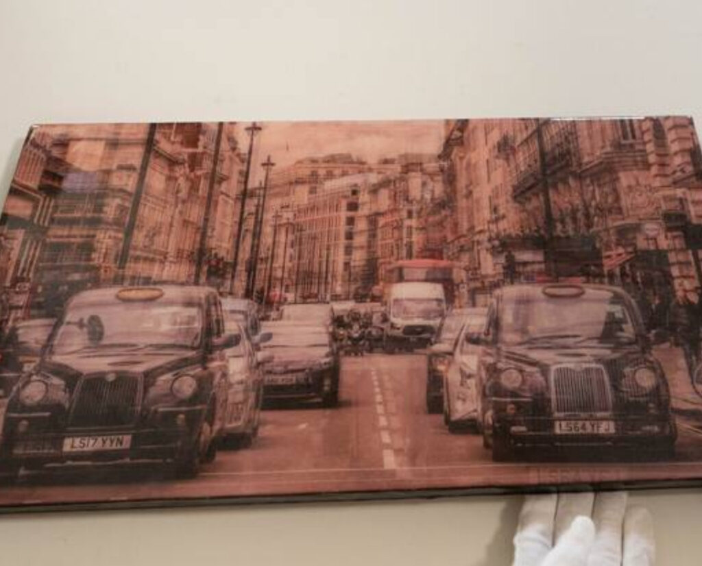 A striking mixed-media artwork by Tomoya Tokano, combining urban landscapes and abstract forms with layered textures