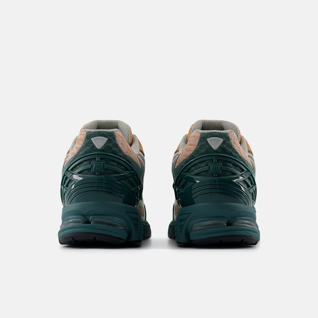 New Balance 1906W sneakers with a retro-modern design, featuring a suede and mesh upper, reflective details, and ABZORB cushioning