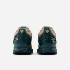 New Balance 1906W sneakers with a retro-modern design, featuring a suede and mesh upper, reflective details, and ABZORB cushioning