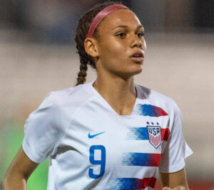 Trinity Rodman showcasing her soccer skills in an NWSL match, highlighting her journey and achievements in professional soccer