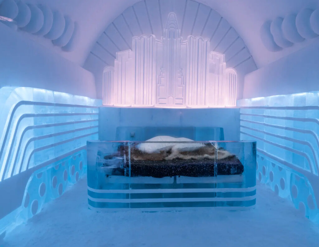 A stunning Art Deco-inspired ice hotel suite from Yesterday’s Tomorrow, featuring geometric ice carvings and soft lighting