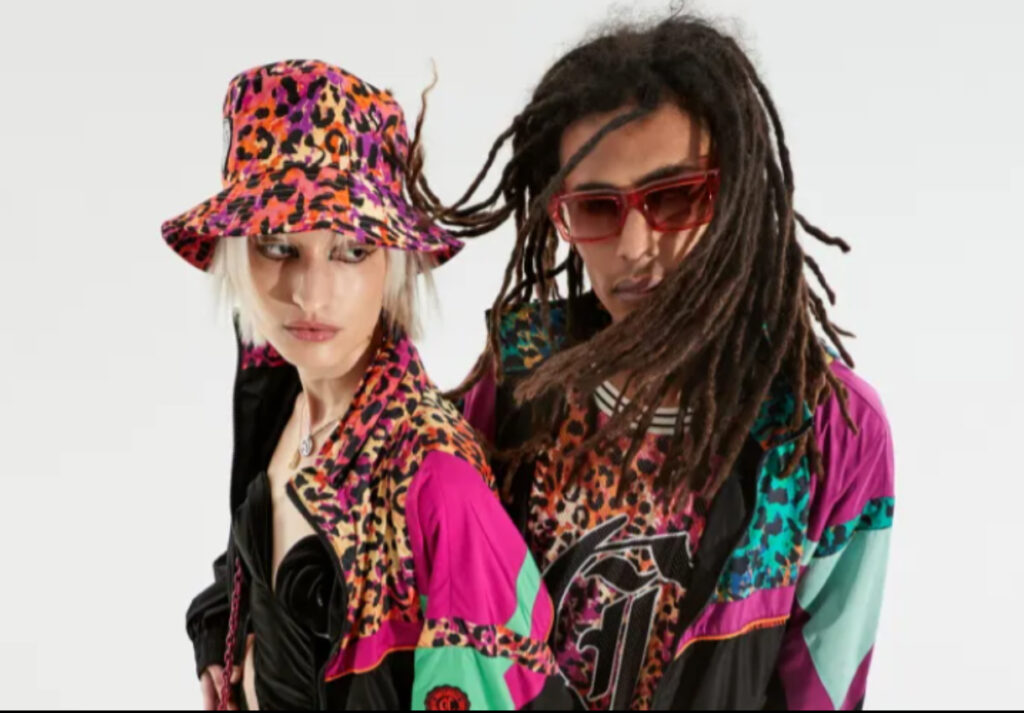 Models showcasing the Just Cavalli Fall 2025 collection, featuring bold prints, streetwear elements, and glamorous details