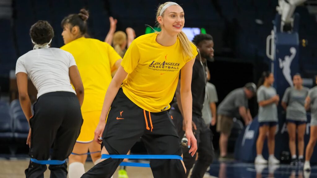 Cameron Brink standing courtside next to Victor Wembanyama at the NBA Paris Game, highlighting their height difference