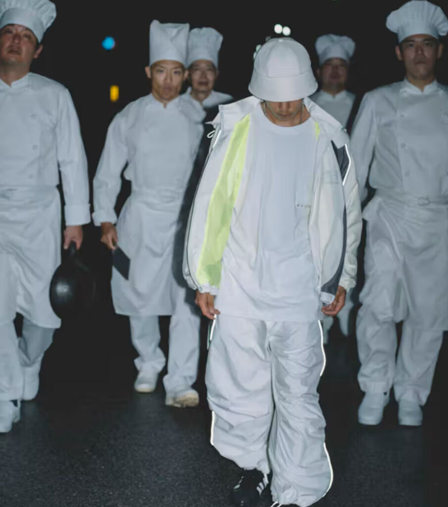 Evisen Spring/Summer 2025 collection featuring water-repellent tracksuits, hunting jackets, sushi graphics, and bold accessories