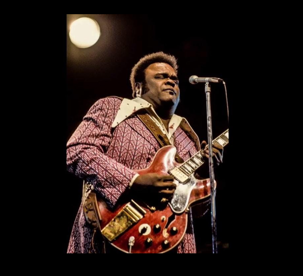 Freddie King playing his Gibson guitar on stage, delivering an electrifying performance of “Going Down”, showcasing blues mastery