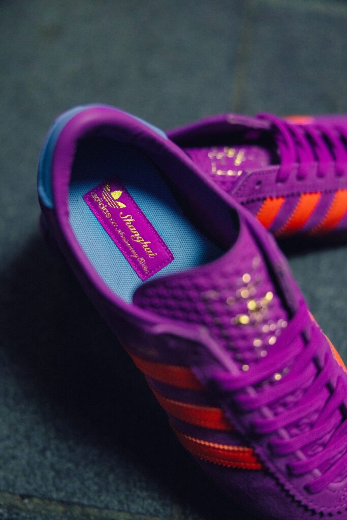 Adidas Shanghai City Series sneaker with purple suede, orange stripes, and gold detailing, launching as a size? exclusive