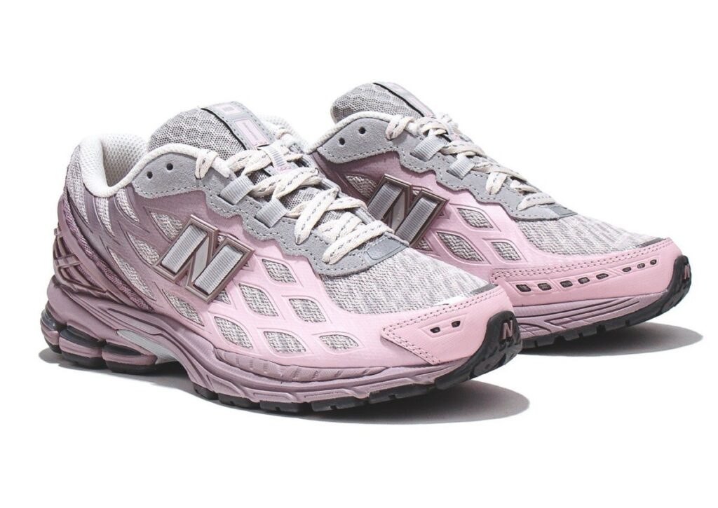 A close-up of the New Balance 1906W “Ice Wine” shoes showcasing its soft pink and grey gradient with mesh upper and sleek design