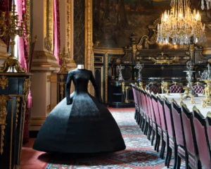 A stunning display at the Louvre’s first fashion exhibition, showcasing iconic haute couture pieces beside historic artworks
