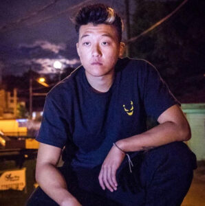 Eric Reprid performing on stage, promoting his song “NBA,” a rap track about ambition and success in the music industry