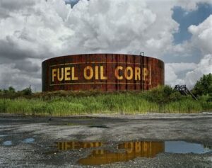 Photograph of an abandoned Detroit industrial building with faded “Fuel Oil” signage, symbolizing urban decay and transformation
