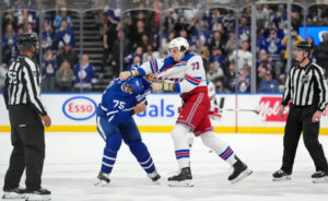Ryan Reaves and Mathieu Olivier drop the gloves in a heated NHL fight, exchanging powerful punches at center ice