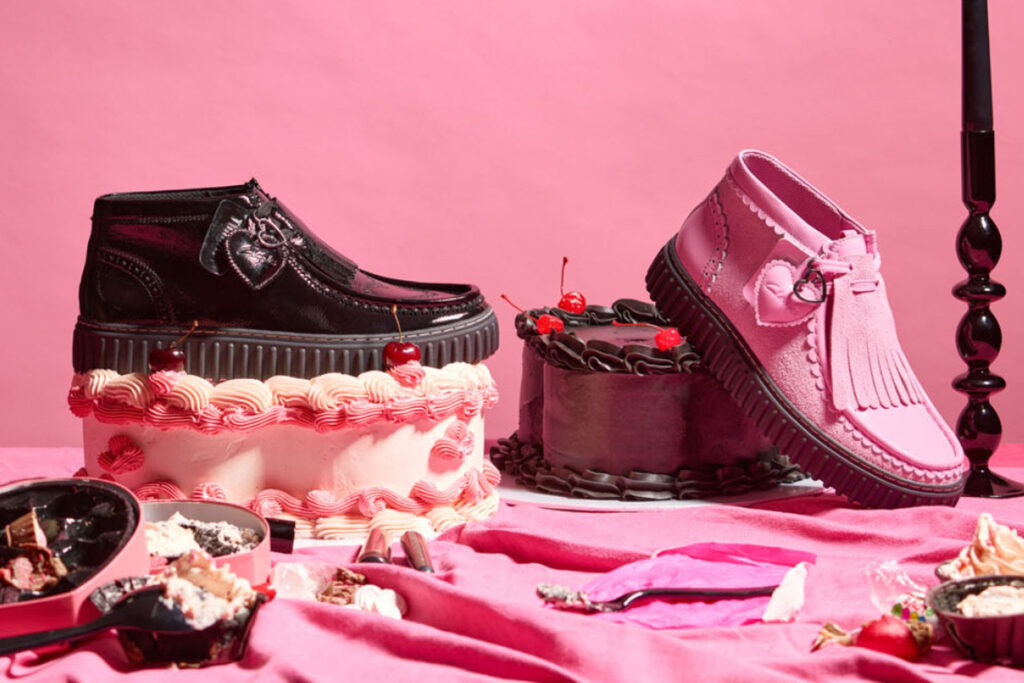 A pair of Clarks Torhill Hi Valentine’s Day Edition boots in red and black velvet, featuring gold-embroidered mystical symbols
