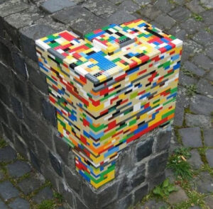 A creative LEGO build filling a structural gap in a brick wall, showcasing LEGO’s versatility in art and repair