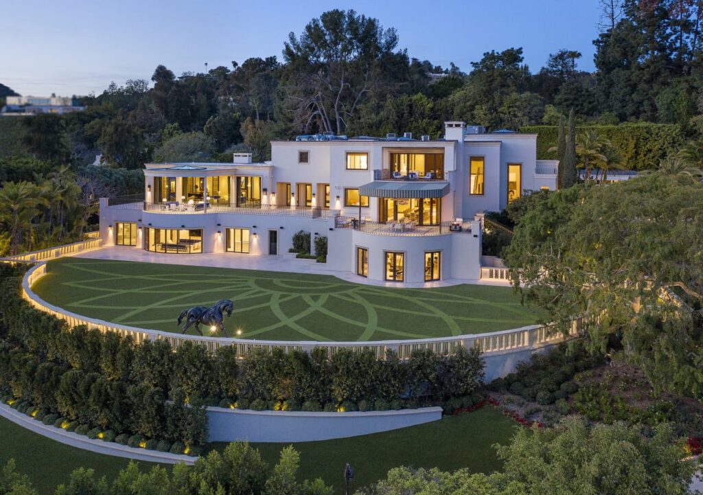 Aerial view of Steve Wynn’s Beverly Hills mansion, featuring a grand entrance, lush landscaping, and a resort-style pool