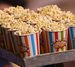 popcorn into a bag, highlighting India’s new tax system that varies based on packaging and seasoning