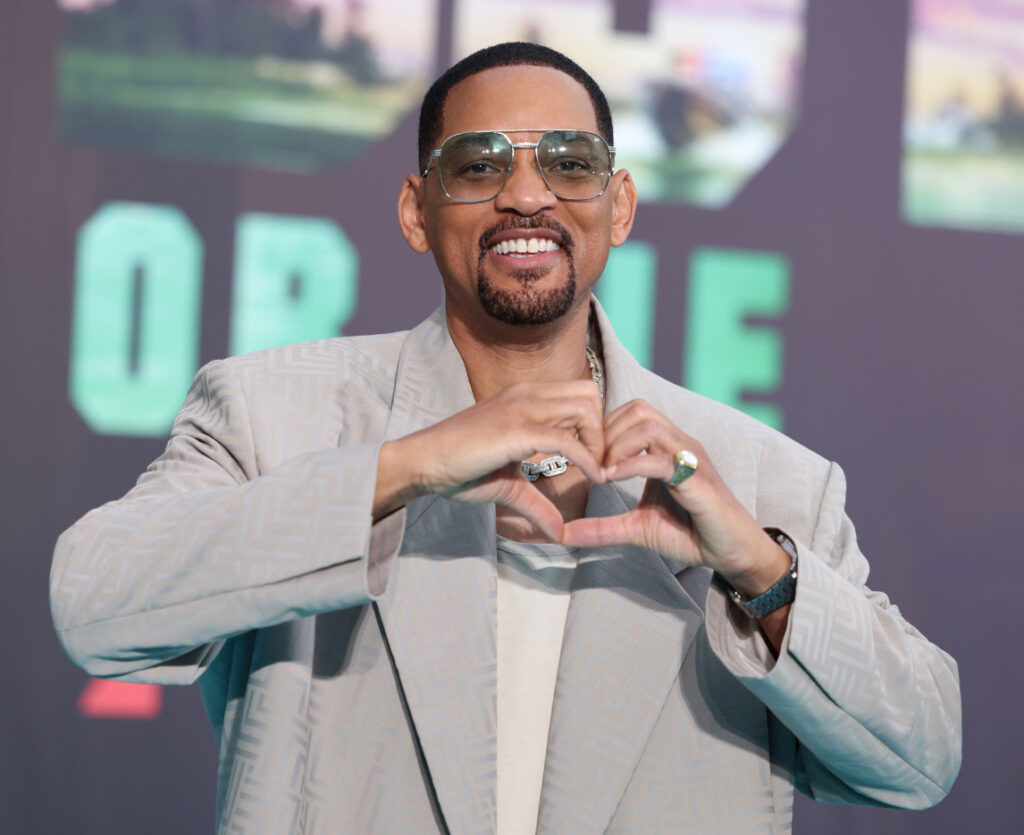 Will Smith on the red carpet, smiling confidently as he makes his Hollywood comeback with new films and projects in the works