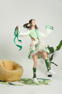 A model wearing a Huili Jin sustainable fashion piece made from upcycled vintage fabrics, blending history with modern design