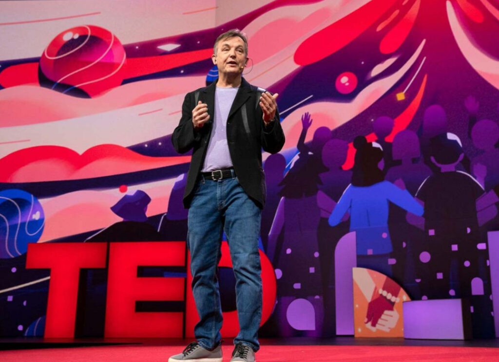 Chris Anderson speaking at a TED conference, announcing the search for a new owner to guide TED’s next 25 year