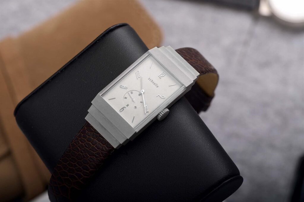 Thomas Schnelle working on a luxury watch movement, showcasing precision craftsmanship and his journey in horology