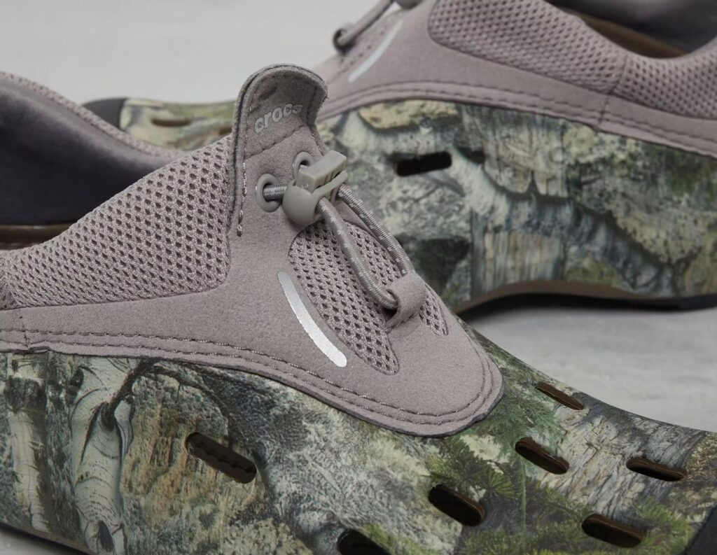 Crocs Quick Trail Mossy Oak sneakers with a green camouflage design, featuring a slip-on style and adjustable drawcord fit