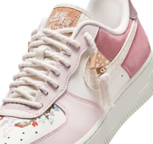 Nike Air Force 1 “Mushroom” shoe featuring pink suede, white leather, floral embroidery, and mushroom-themed lace charms