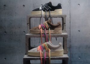 A close-up of the ANTA Hélà Style Roots Pack, featuring monochromatic suede design and bold two-tone layered laces