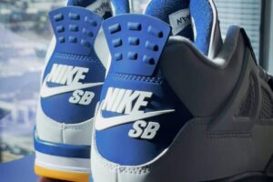 Nike SB x Air Jordan 4 “Navy” sneaker featuring a white leather upper, navy accents, red Jumpman logo, and gum rubber outsole