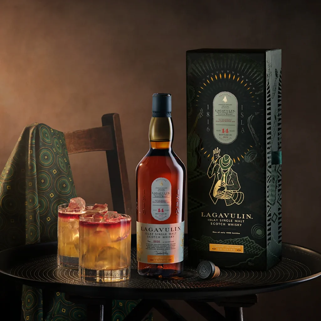 Lagavulin whisky bottle alongside Connor McKnight’s refined fashion pieces, symbolizing their shared commitment to craftsmanship