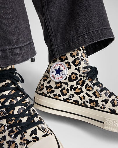 A pair of Leopard Print Converse sneakers, blending classic Chuck Taylor design with bold animal print patterns for a trendy look