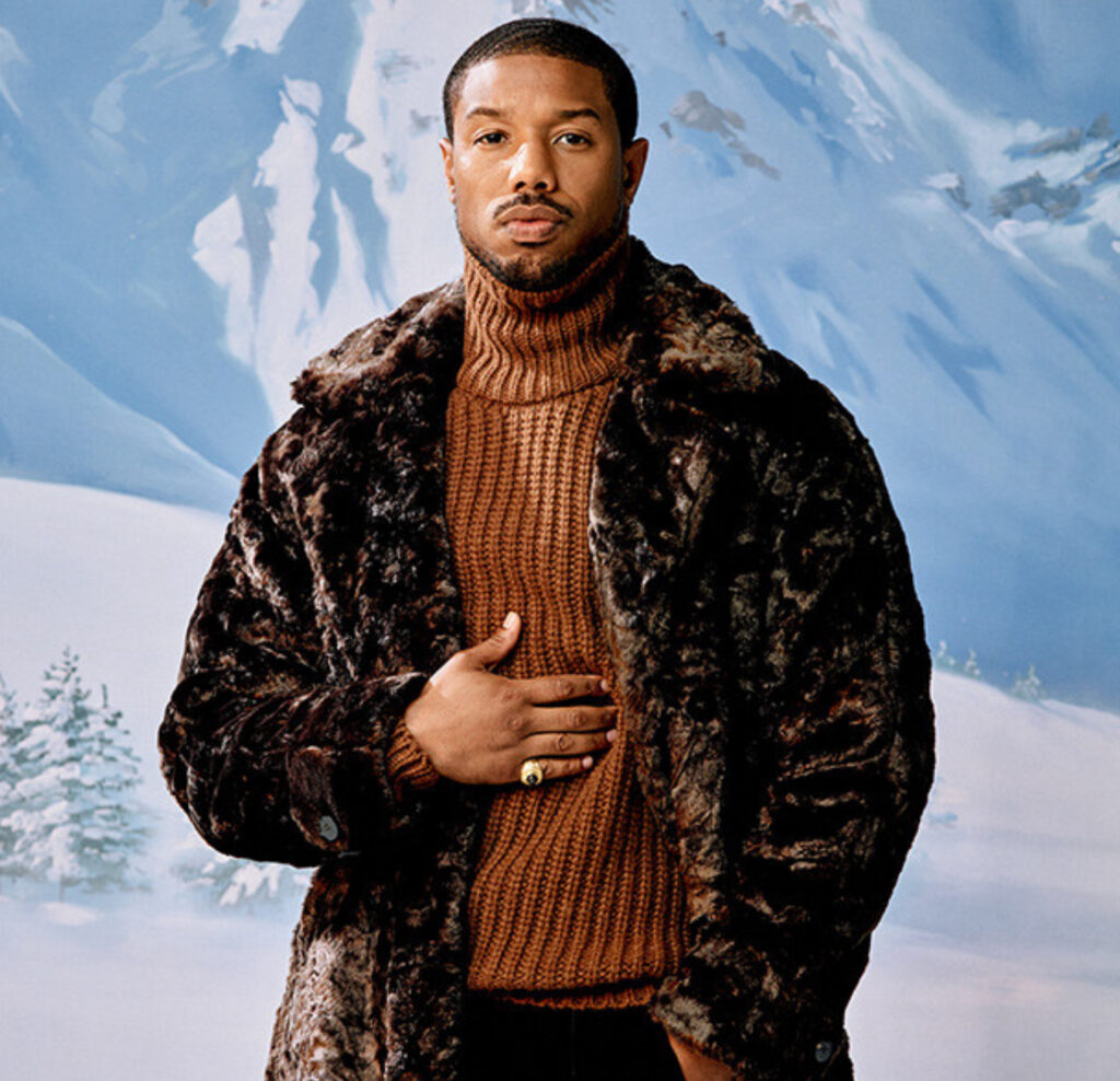 Michael B. Jordan in a stylish suit, discussing his most memorable roles during an exclusive interview with GQ