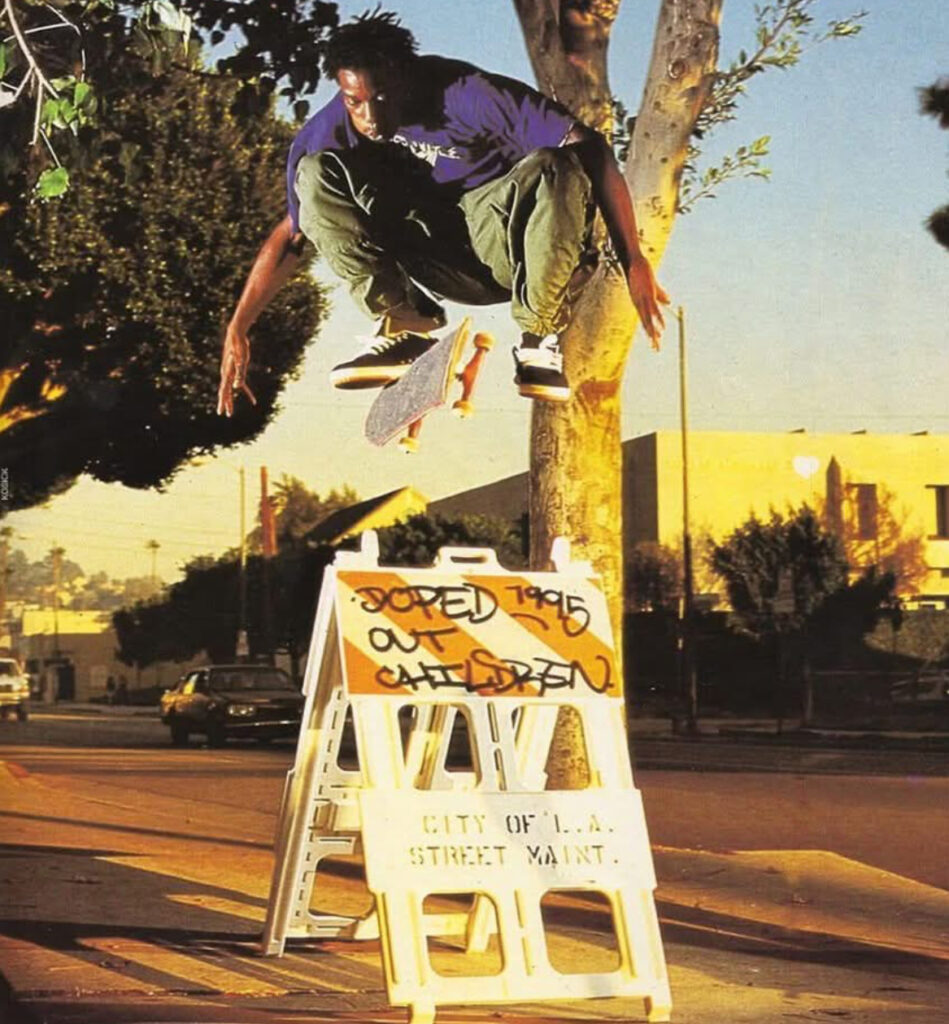 Kareem Campbell mid-trick in 1995, showcasing his smooth and technical street skating style, influencing a generation of skaters