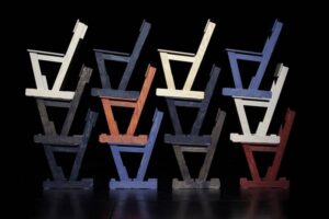 A minimalist Protect Your Rights Chair by Blä Station, crafted from pine plywood with a symbolic metal plate on the backrest