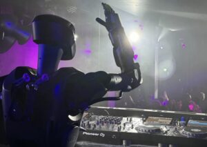 Phantom, the humanoid war robot, DJing at a San Francisco nightclub, showcasing its impressive skills and versatility
