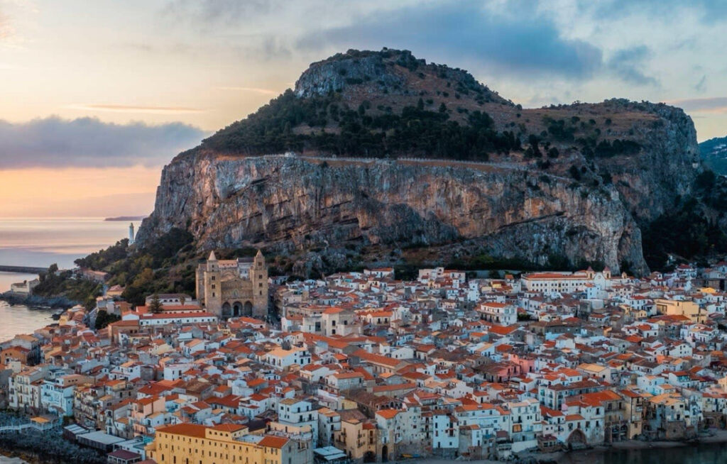 A scenic view of Sicily's picturesque coastline, highlighting the island's diverse attractions, from sunny beaches to lush lemon groves