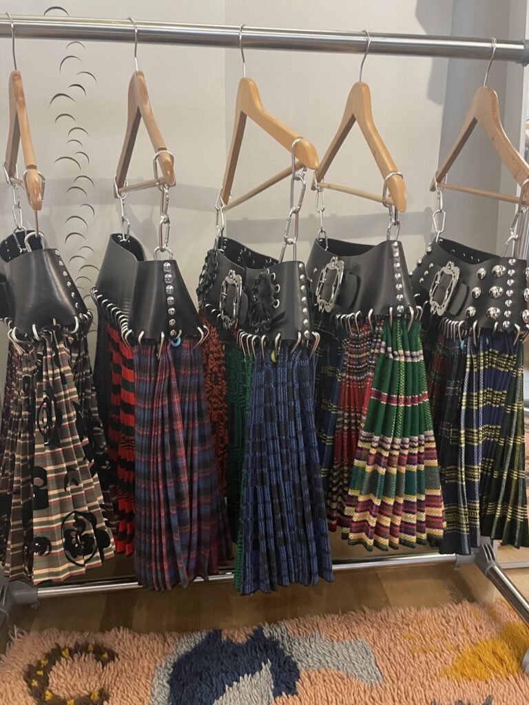 Digital rendering of the iconic Chopova Lowena pleated skirt, showcasing its bold patterns and voluminous silhouette within virtual environments