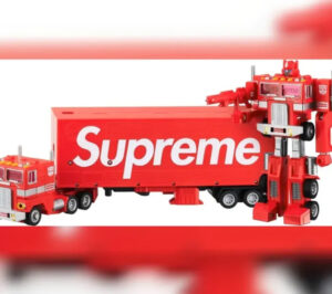 Official image of Supreme x Transformers Optimus Prime collaboration, showcasing G1 mold with red deco and Supreme logo on the trailer