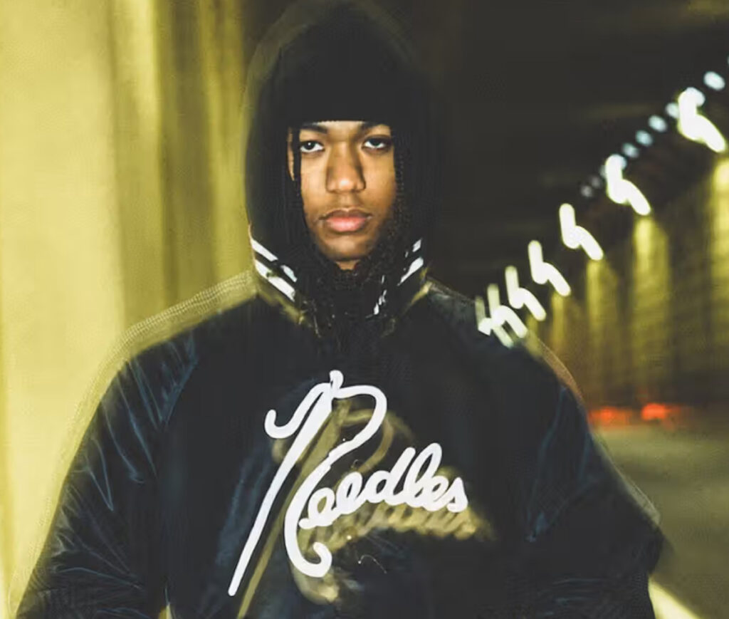 Black nylon stadium jacket from the BEAMS x NEEDLES Capsule Collection featuring subtle brand iconography and sleek design
