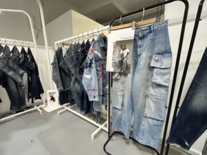 The iconic blue hands logo of Les Mains Bleues, representing the company's influential role in shaping the denim industry and its evolution in fashion and culture