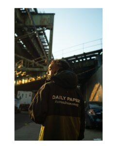 A model wearing a piece from the Daily Paper x Street Dreams Magazine capsule collection, showcasing the mix of sportswear and futuristic design
