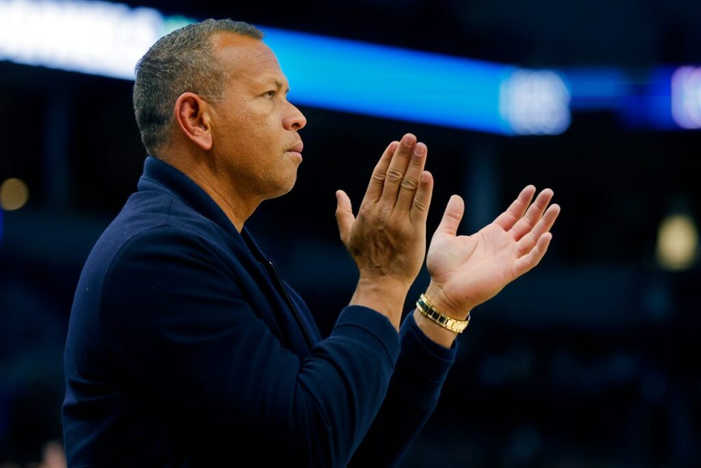 Alex Rodriguez celebrates after making a half-court shot at Bucknell, winning a student $10,000 during a basketball game