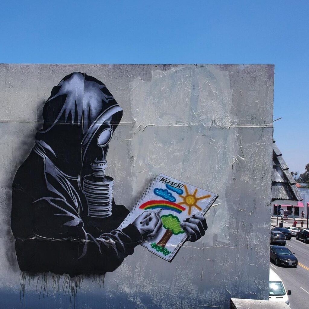 A striking HIJACK street art piece featuring bold stencil work, vibrant colors, and surreal elements in an urban setting