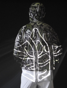 A model wearing the Palace x Maharishi SS25 asymmetric jacket and convertible cargo pants, blending military and skate aesthetics