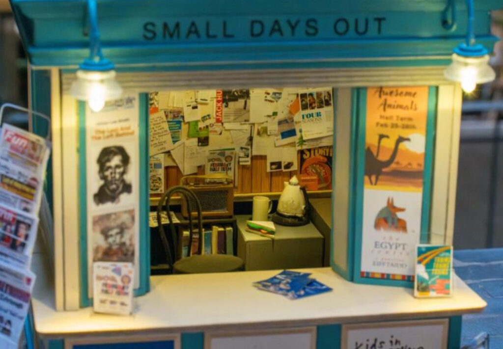 A family enjoying a Small Day Out at a local museum, engaging with an interactive exhibit designed for children