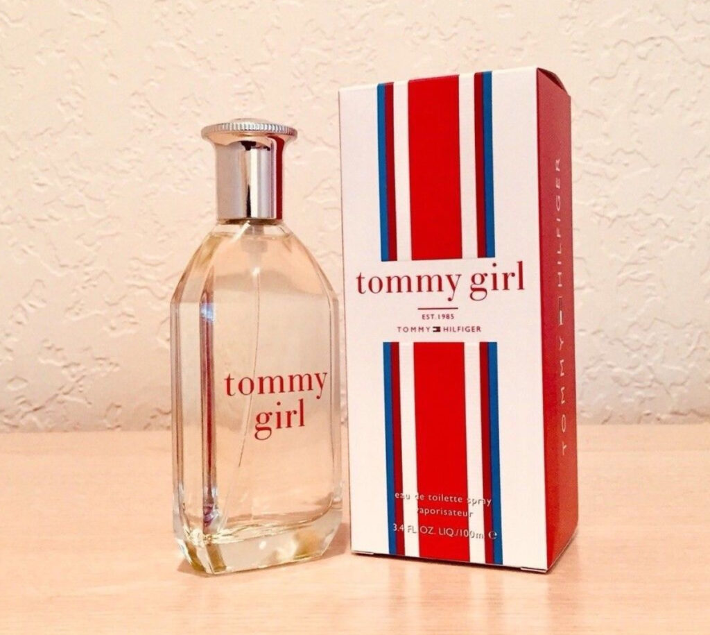 A bottle of Tommy Girl fragrance, the iconic ‘90s perfume with fresh floral and citrus notes, capturing youthful nostalgia