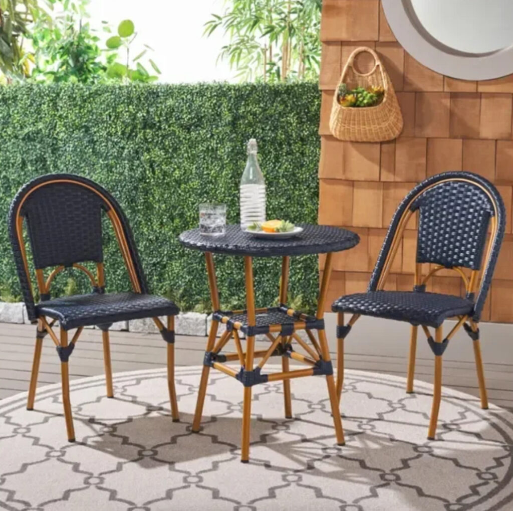 A stylish Adreian 2-Person Round Outdoor Dining Set with a round table and two chairs, ideal for compact outdoor spaces