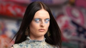Runway model from Diesel’s Fall/Winter 2025-2026 collection, wearing a distressed denim outfit with futuristic textures
