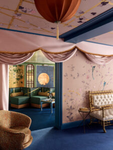 A hand-painted wallpaper panel featuring intricate floral motifs, exotic birds, and Chinoiserie-inspired landscapes